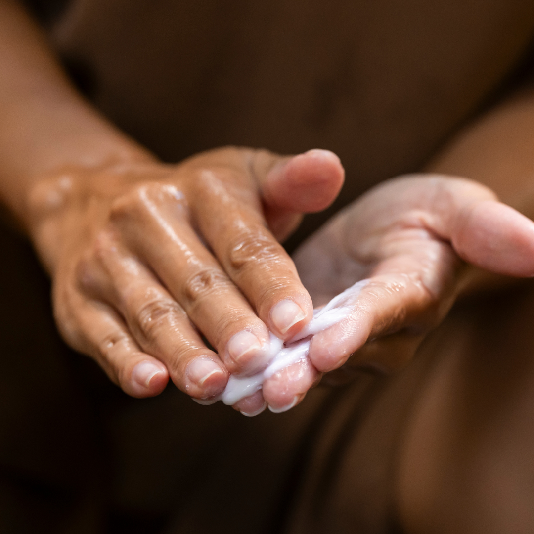 Woman rubbing and lathering cleanser in her hands